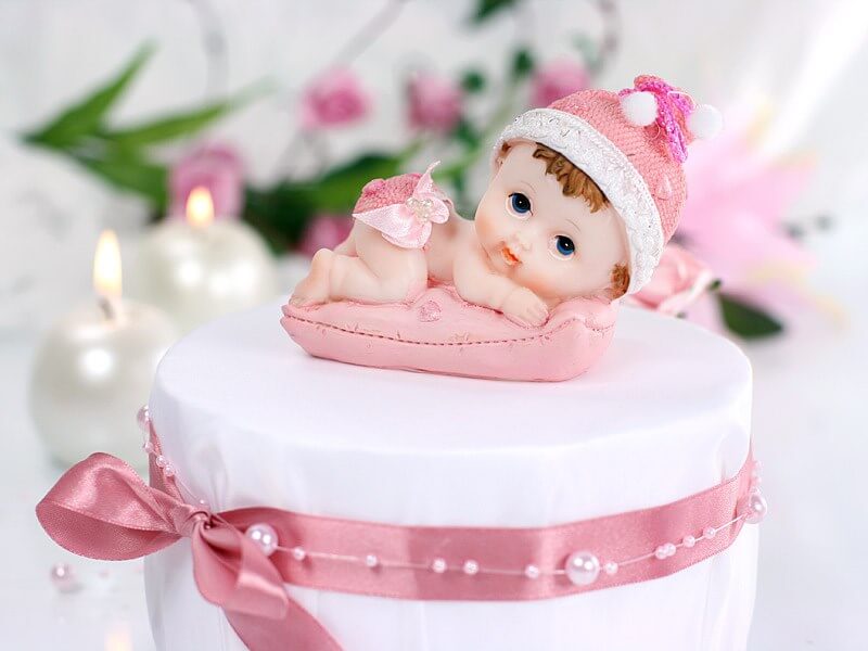 Figurine Bébé Fille sur un coussin rose